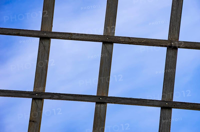 Wooden lattice against a blue sky, detail of a wing of a traditional windmill near the village of Sunnersberg near Lidköping, Västergötland, Västra Götalands län, Sweden