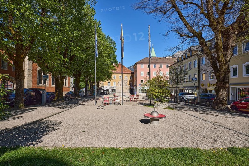 Square, general architecture, flagpoles, flags, trees, lawn, blue sky, cloudless, Unterer Lindenplatz, Bad Reichenhall, Berchtesgadener Land district, Bavaria, Germany
