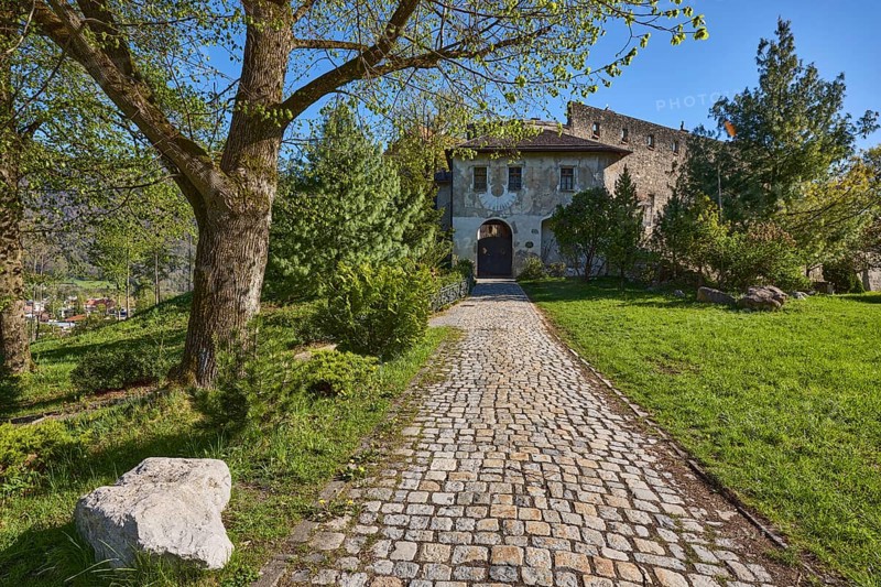 Castle Gruttenstein, footpath, cobblestones, entrance, trees, lawn, blue sky, cloudless, Pfannhauserweg, Bad Reichenhall, district Berchtesgadener Land, Bavaria, Germany