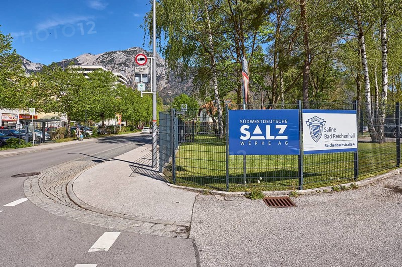 Südwestdeutsche Salzwerke AG, Bad Reichenhall salt works, metal fence, advertising sign, trees, lawn, general architecture, mountain landscape, mountains, road, blue sky, cirrostratus clouds, Reichenbachstrasse, Bad Reichenhall, Berchtesgadener Land district, Bavaria, Germany