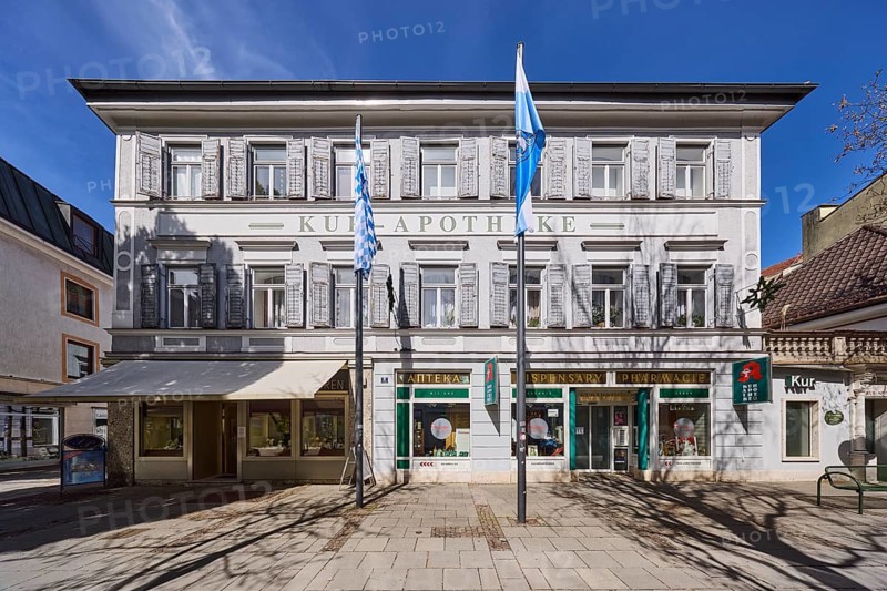Kur-Apotheke, historical pharmacy, building, flagpoles, flags, facade, windows, entrance, doors, blue sky, cirrostratus clouds, Ludwigstraße, Bad Reichenhall, district Berchtesgadener Land, Bavaria, Germany