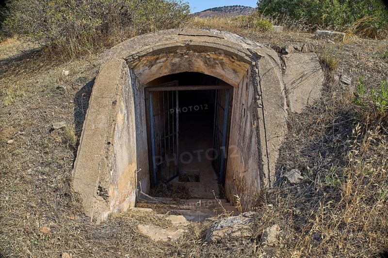 Dilapidated bunker entrance in nature, leading into the darkness, Italian air defence position, ground defence position, PL306 with 6 cannons, WW2, Vigla Mountain, Vigla, above Lakki, Lakki, Leros, Dodecanese, Girech Islands, Greece