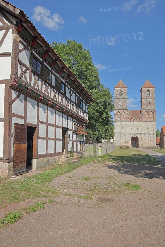 Half-timbered house and Romanesque St Mary's Collegiate Church with twin towers, church ruins, museum, Veßra Monastery, cobblestone, Thuringia, Germany