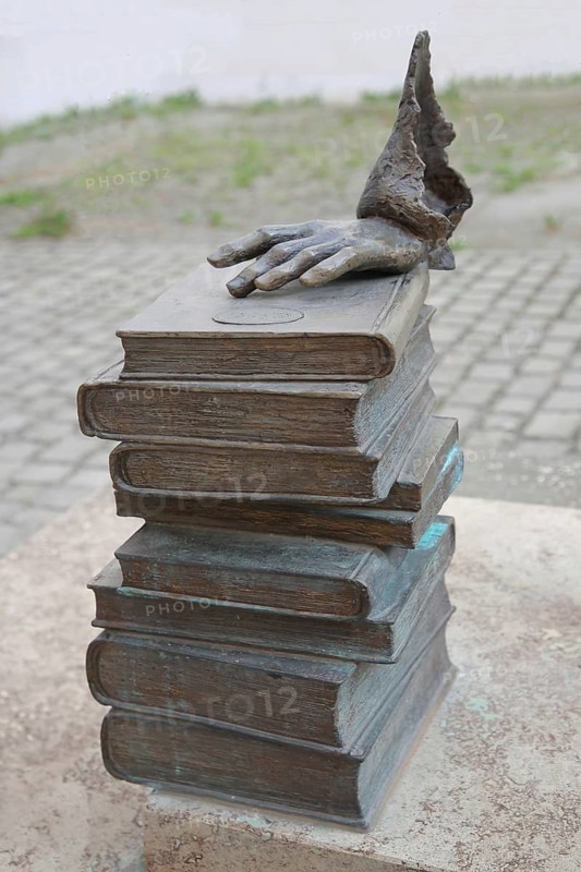 Monument to merchant, publicist and publisher Carl Joseph Meyer, sculpture, modern art, pile of books with hand on book, fingers, books, stacked, Hildburghausen, Franconia, Thuringia, Germany