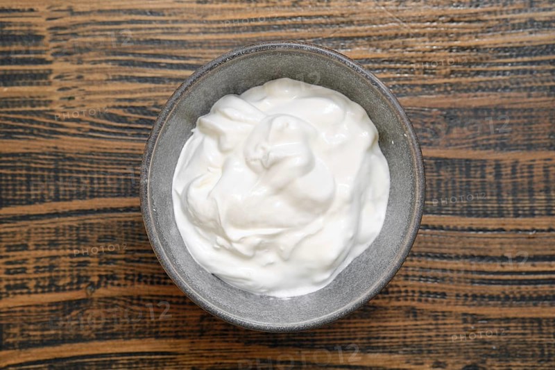 Overhead view of a bowl with sour cream or greek yoghurt