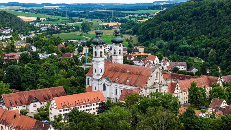 Zwiefalten Monastery, former Benedictine abbey. Tourist landmark on the southern foothills of the Swabian Alb in the district of Reutlingen. Drone photo. Zwiefalten, Baden-Württemberg, Germany