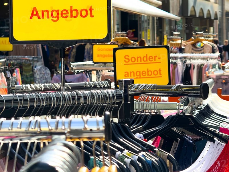 Summer dresses in bright colours on a clothes rack in a street sale in Wuppertal, Germany