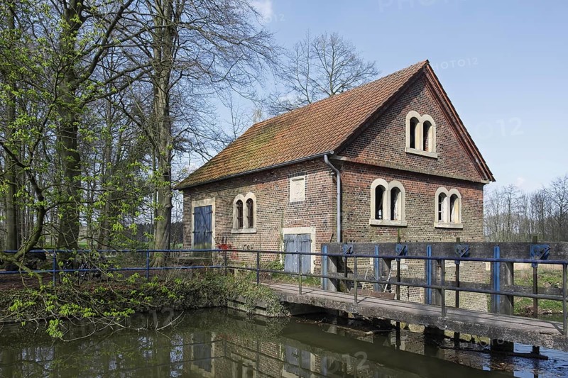 Old watermill with weir, Münsterland, North Rhine-Westphalia, Germany