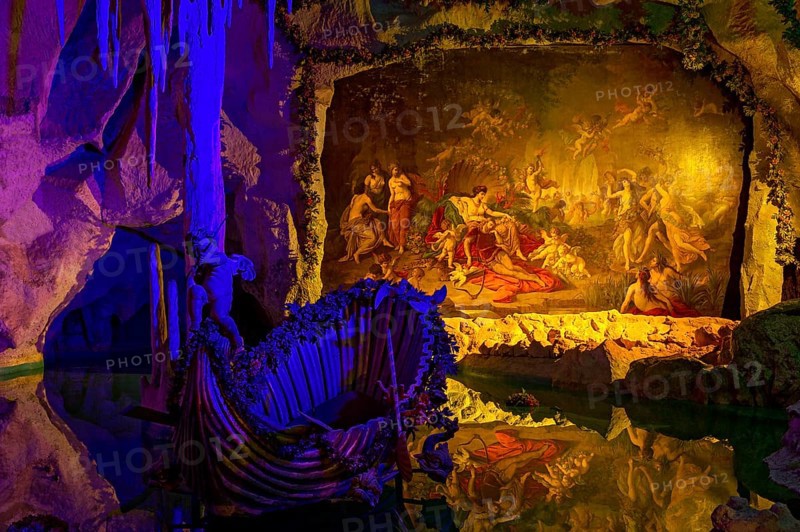 Colourful illumination of King Ludwig II's Venus Grotto, artificial stalactite cave, lake with boat, painting Tannhäuser bei Frau Venus by August von Heckel, park of Linderhof Castle, UNESCO World Heritage Site, Ettal, Unterammergau, Garmisch-Partenkirchen, Upper Bavaria, Bavaria, Germany