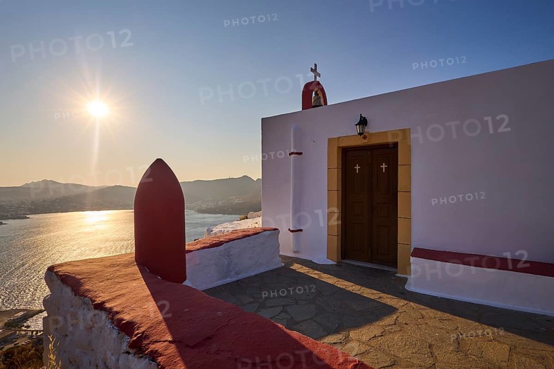 Chapel with cross by the sea at sunset, peaceful atmosphere and classic Greek architecture, red painted world war bomb, Profitis Ilias Church, Prophet Elias Church, evening light, sunset, Ormos Alintas, Agia Marina, Leros, Dodecanese, Greek Islands, Greece