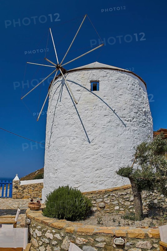 White windmill with propeller and rock garden under blue sky on an island, Pandeli Castle, Castle, Leros Fortress, St John's Fortress, Apitiki Hill, Pandeli Bay, Windmills, Leros, Dodecanese, Greek Islands, Greece