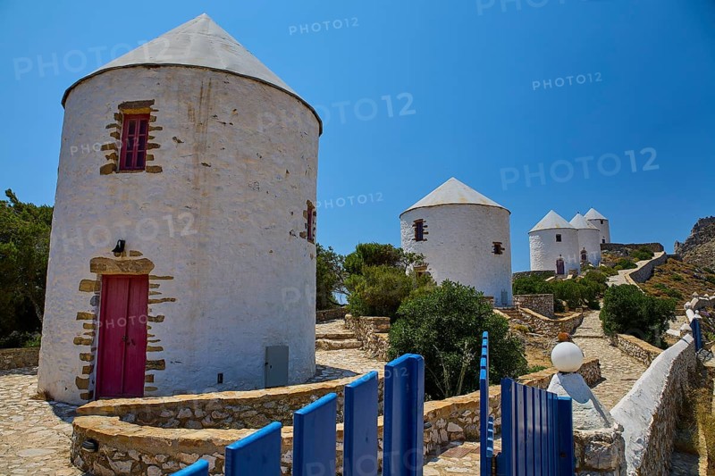 White windmills with red doors and fence under a blue sky on a sunny island, Pandeli Castle, Castle, Leros Fortress, St John's Fortress, Apitiki Hill, Pandeli Bay, Windmills, Leros, Dodecanese, Greek Islands, Greece