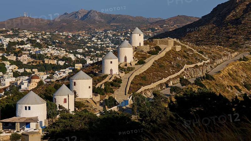 Row of windmills overlooking village, nestled in hilly landscape, Pandeli Castle, Castle, Leros Fortress, St John's Fortress, Apitiki Hill, Pandeli Bay, Windmills, Leros, Dodecanese, Greek Islands, Greece