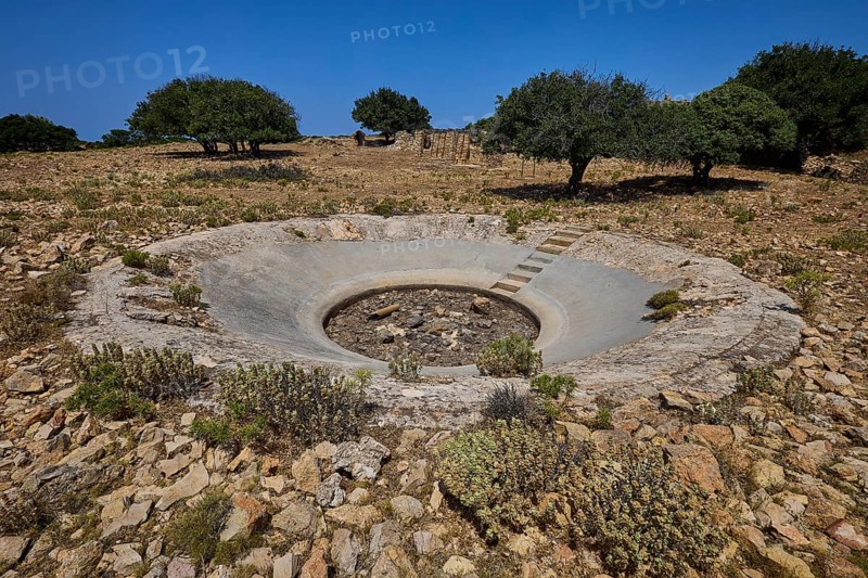 Round concrete construction in a barren landscape with trees and stones, Lost Place, Air Defence Position, Aerophone, Parabolic Acoustic Mirror, Patella Mountain, WW2, west of Lakki, Leros, Dodecanese, Greek Islands, Greece