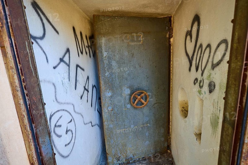 Lost Place, Small room with graffiti-covered metal door and worn appearance, Radio Station, WW2, Agios Nikolaos Radio, Agia Marina, Leros, Dodecanese, Greek Islands, Greece