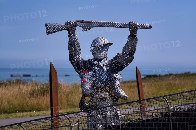 Sculpture by Bill Pendell MM, British World War II veteran, looking back at himself and his comrades in the Battle of Gold Beach, D-Day 75 garden, also Le Jardin du Souvenir, D-Day, Operation Overlord, Mulberry B, Mulberry Harbour, Gold Beach, beach, Port Winston, Arromanches-les-Bains, Normandy, Calvados, France