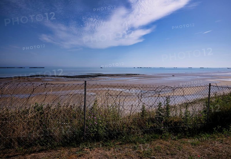Barbed wire in front of Phoenix Caissons, caissons, concrete boxes, were used in the sea as breakwaters and to form an improvised harbour, Mulberry B Harbour, Mulberry Harbour, Port Winston, Gold Beach, beach, D-Day, Operation Overlord, Arromanches-les-Bains, Normandy, Calvados, France
