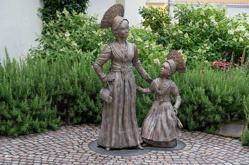 Two bronze sculptures, Überlingen women in festive traditional costume, created in 2023 by the sculptor Daniela Einsdorf, Überlingen, Baden-Württemberg, Germany