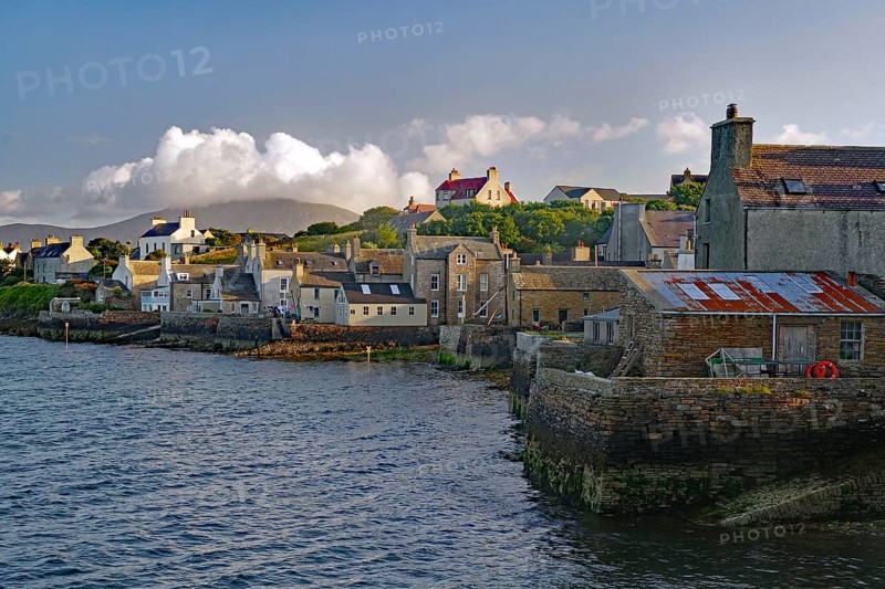 Numerous buildings at a stone harbour under a cloudy sky, Stromness, Mainland, Orkney Islands, Scotland, United Kingdom