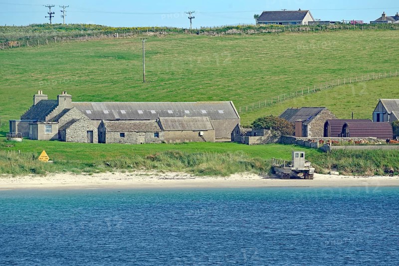 Rural scene with houses by the sea and green fields in the background, Lambholm, Orkney Islands, Scotland, Great Britain