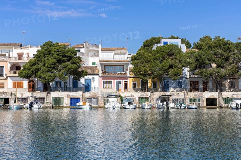Portocolom fishing village on Majorca with boats and colourful houses Holiday by the sea in Portocolom, Spain