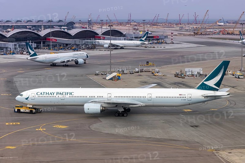 A Cathay Pacific Boeing 777-300 aircraft with the registration B-HNH at Chek Lap Kok Airport (HKG) in Hong Kong, China