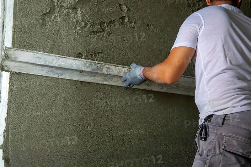 Plasterer smoothing interior walls