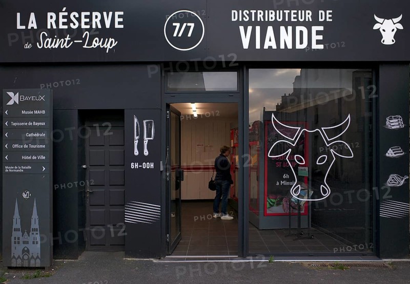 Woman standing in self-service butcher, butcher's shop, self-service, vending machine, meat vending machine, meat products, food, Bayeux, Normandy, Calvados, France