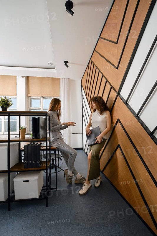 Two women stayed up late discussing their app for monitoring women's health in a startup office space