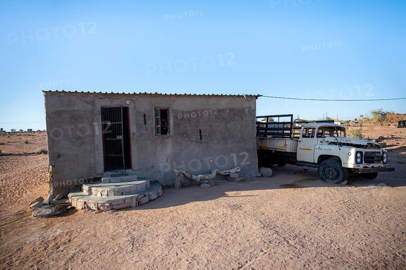 Simple house and old transport vehicle in a small village, Erongo, Damaraland, Namibia