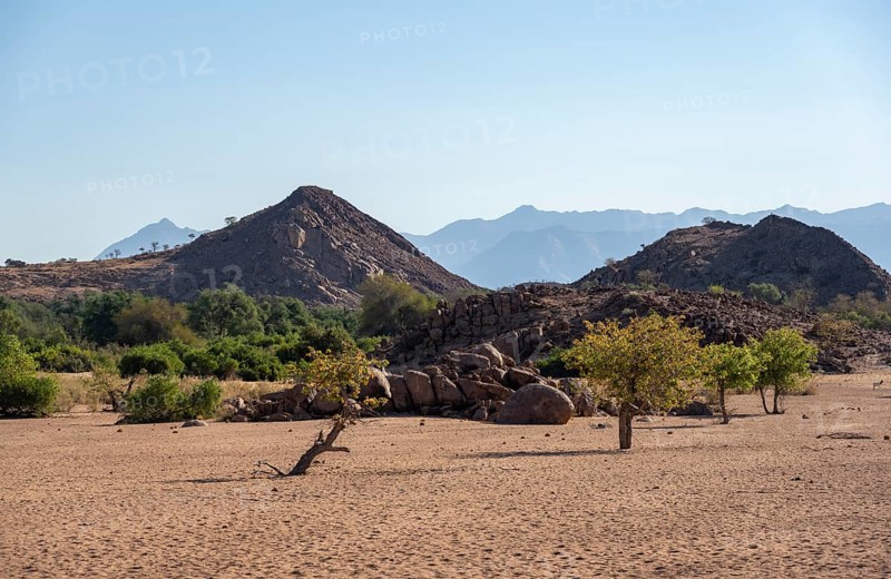 Dry riverbed of the Ugab River, barren landscape with hills of stacked rocks, desert landscape, Erongo, Damaraland, Namibia