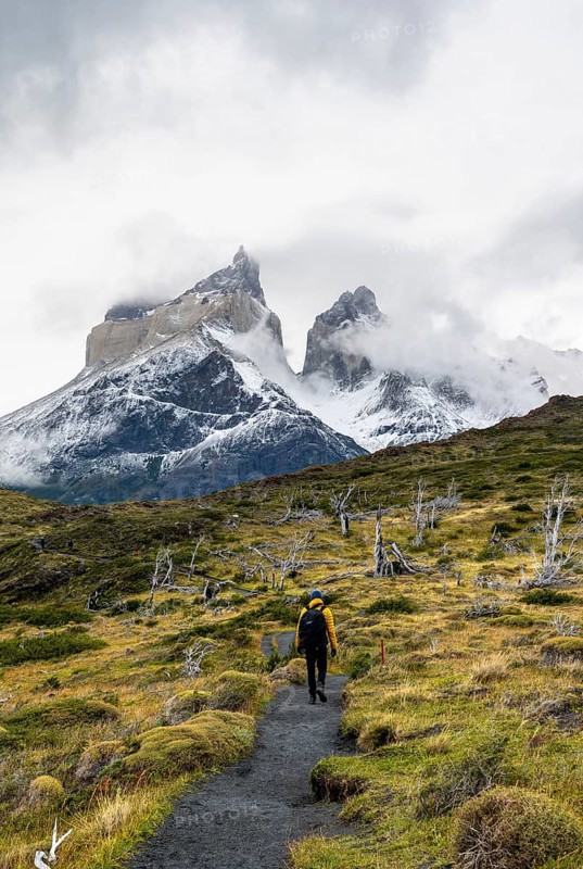 Hikers on a hiking trail to the Mirador de los Cuernos, Cuernos del Paine mountain range in autumn, Torres del Paine National Park, Magallanes region, Chile