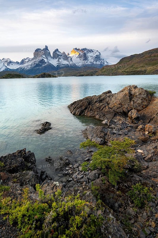 Cuernos del Paine mountain range at sunset, shore of the blue lake Lago Pehoe, Torres del Paine National Park, Chile
