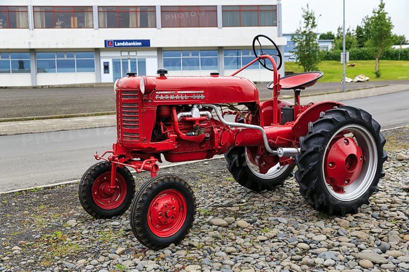 Red vintage car, McCormick Farmall tractor by the roadside, Hvammstangi, Vatnsnes, Iceland