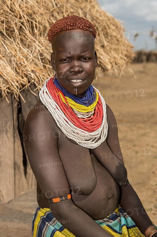 Woman of the Nyangatom ethnic group, also called Bume, with colourful bead necklaces and the typical copper-coloured hair style, Southern Omo Valley, Ethiopia