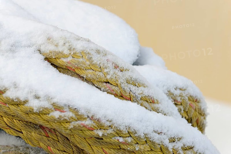 Thick ship rope covered with snow, close-up, North Sea, Norddeich, Lower Saxony, Germany