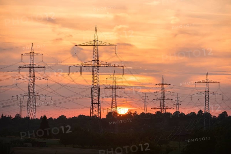 Power lines towering into the evening sky during a sunset, Waiblingen, Baden-Württemberg, Germany