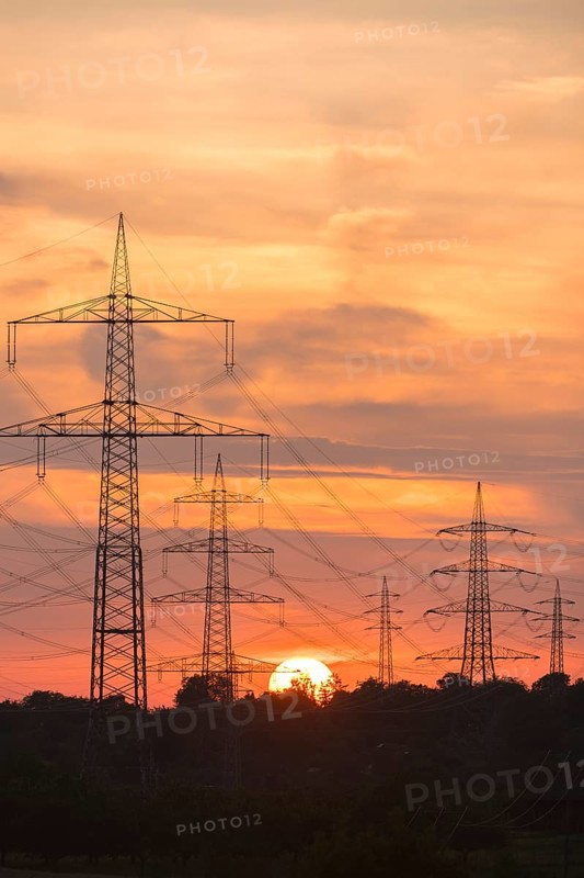 High-voltage power lines at sunset with intense orange sky, Waiblingen, Baden-Württemberg, Germany