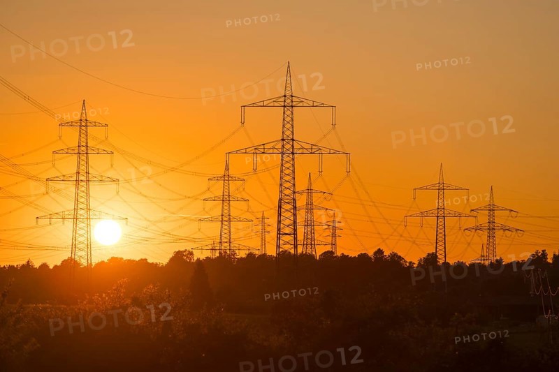 Imposing silhouettes of electricity pylons in front of an intense sunset, Waiblingen, Baden-Württemberg, Germany