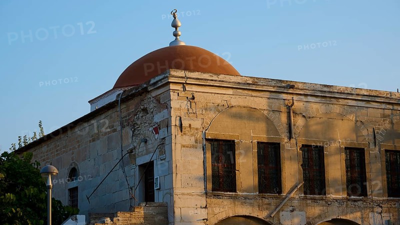 Defter-dar Mosque, Eleftherias Square, Historic building with red dome and old stone walls in the soft sunlight, Kos Town, Kos, Dodecanese, Greek Islands, Greece