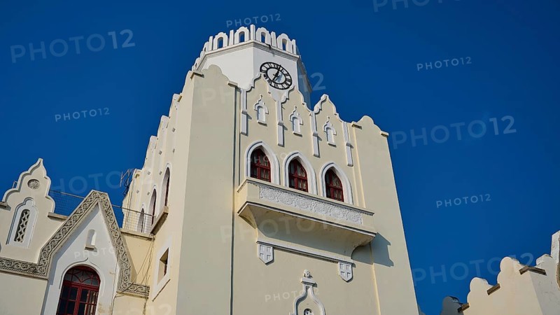 Palace of Justice, colonial building, Gothic-style bell tower with clock and battlements under a clear blue sky, Kos Town, Kos, Dodecanese, Greek Islands, Greece