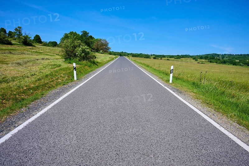 Straight country road runs through open landscape with blue sky, summer, Franzosenweg, Lange Rhön, Oberelsbach, Rhön, Bavaria, Germany