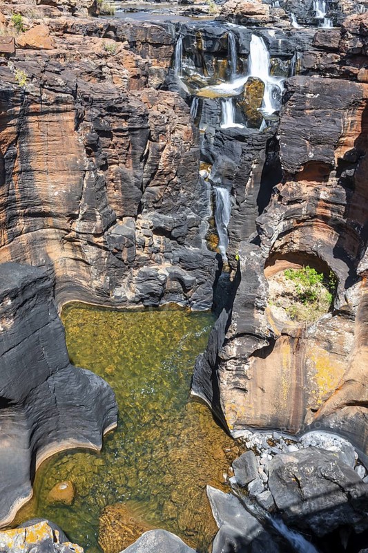 Waterfall on orange-coloured rock cliffs, long exposure, Blyde River, Bourke's Luck Potholes, Panorama Route, Mpumalanga, South Africa