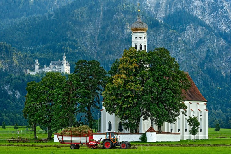 Pilgrimage church of St Coloman, Baroque, Neuschwanstein Castle by King Ludwig II, fairytale castle in the neo-Romanesque style, UNESCO World Heritage Site, tractor with hay cart in the field, Schwangau, Füssen, Allgäu, Swabia, Bavaria, Germany