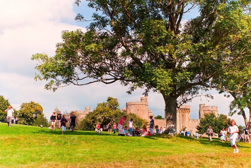 Tourists and locals in front of Bodiam Castle, located in East Sussex near the River Rother. It has long been one of England's most popular and best-known castles. England, UK