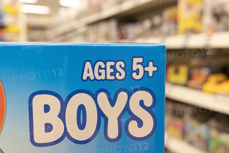 Close-up of Ages 5+ Boys text on blue toy packaging highlighting color gender coding. Generative ai, AI generated