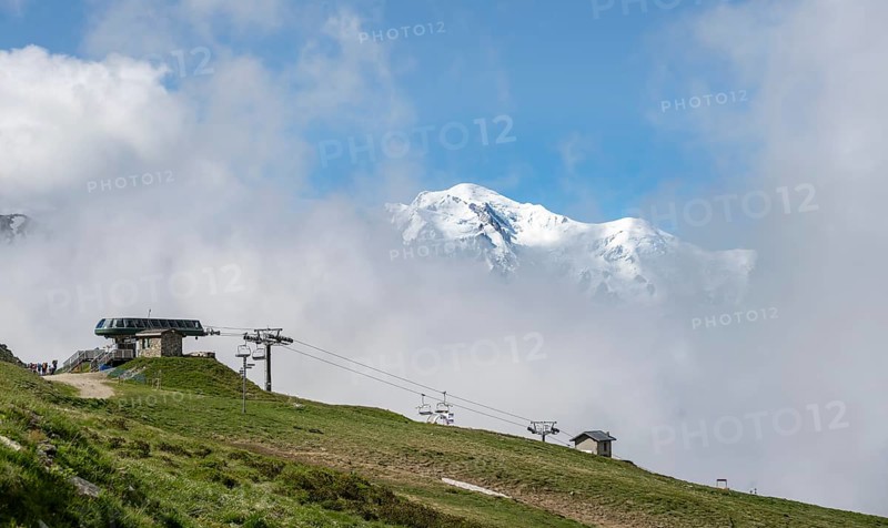Ski lift in the Domaine de Balme ski area at Col de Balme, in summer, behind the summit of Mont Blanc, Chamonix, Haute-Savoie, France