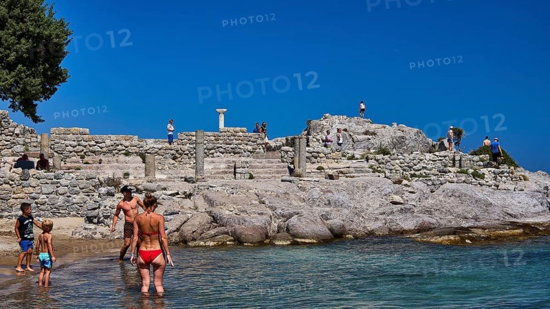 People and children exploring ancient ruins on the beach in sunny weather, Agios Stefanos Beach, Agios Stefanos Basilica, Basilica, Kastri Island, Kos, Dodecanese, Greek Islands, Greece