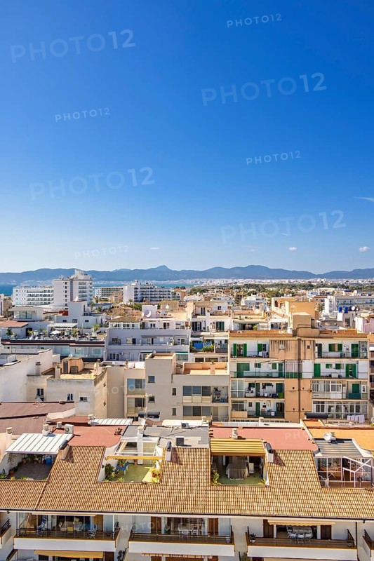 Skyline view above the house roofs in a city with tower blocks in a residental area, Can Pastilla, Mallorca, Spain