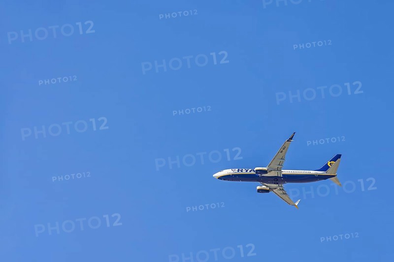 Ryanair passenger plane flying in a blue sky
